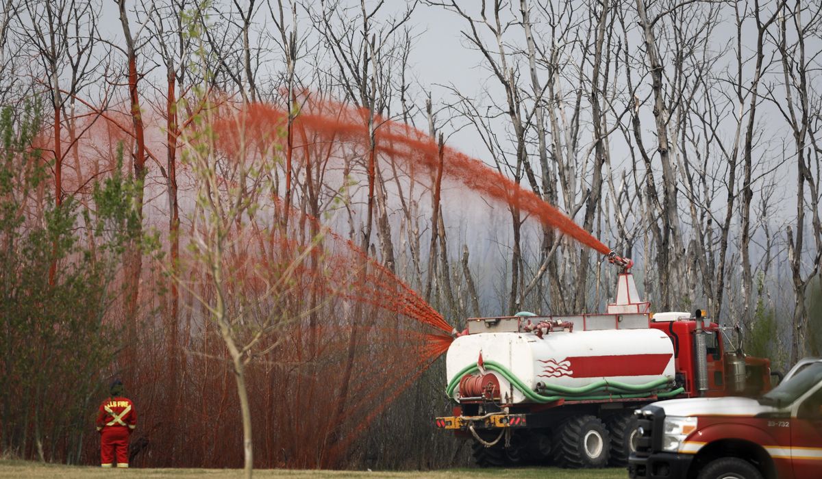 NextImg:Canadians are hopeful shifting winds may push wildfire away from the oil sands hub of Fort McMurray