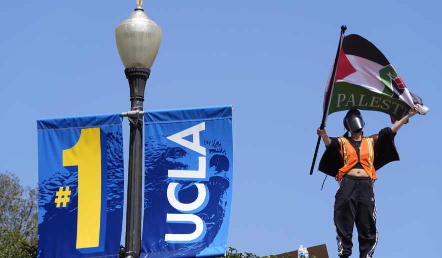 Demonstrators wave flags on the UCLA campus, after nighttime clashes between Pro-Israel and Pro-Palestinian groups, May 1, 2024, in Los Angeles. If the University of California, one of the largest public university systems in the country, were to agree to divestment calls from students protesting the Israel-Hamas war, the system would lose $32 billion of its overall $175 billion in assets, officials said on Tuesday, May 15, 2024. (AP Photo/Jae C. Hong) **FILE**