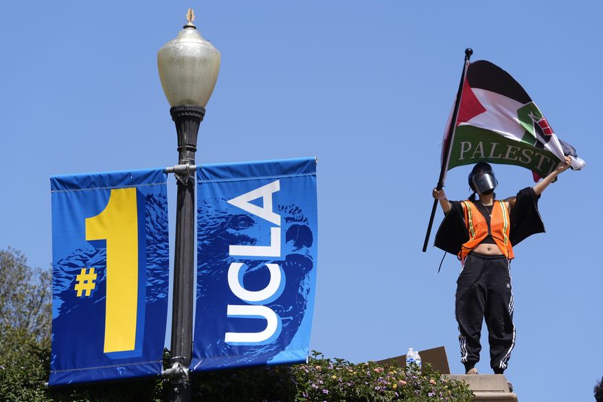 Demonstrators wave flags on the UCLA campus, after nighttime clashes between Pro-Israel and Pro-Palestinian groups, May 1, 2024, in Los Angeles. If the University of California, one of the largest public university systems in the country, were to agree to divestment calls from students protesting the Israel-Hamas war, the system would lose $32 billion of its overall $175 billion in assets, officials said on Tuesday, May 15, 2024. (AP Photo/Jae C. Hong) **FILE**