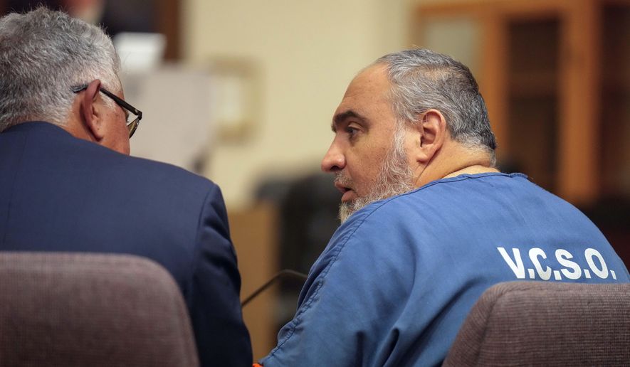 Attorney Ron Bamieh, left, listens to his client, Loay Abdelfattah Alnaji, a professor of computer science at Moorpark College, in Ventura County Superior Court on Nov. 17, 2023, in Ventura, Calif. A judge decided Wednesday, May 15, that Alnaji will stand trial for involuntary manslaughter and battery in the death of a Jewish counter-protester during demonstrations over the Israel-Hamas war last year. (AP Photo/Damian Dovarganes, File)