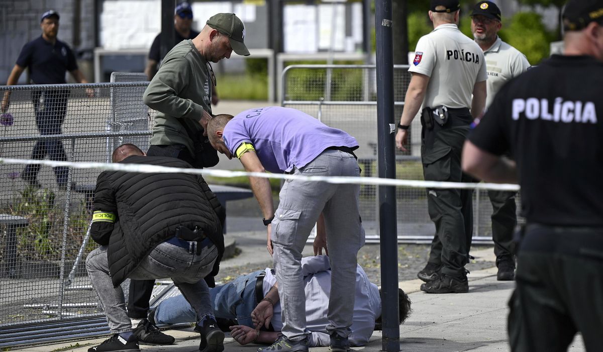 NextImg:Suspect in shooting of Slovak prime minister is escorted to his home as police search for evidence
