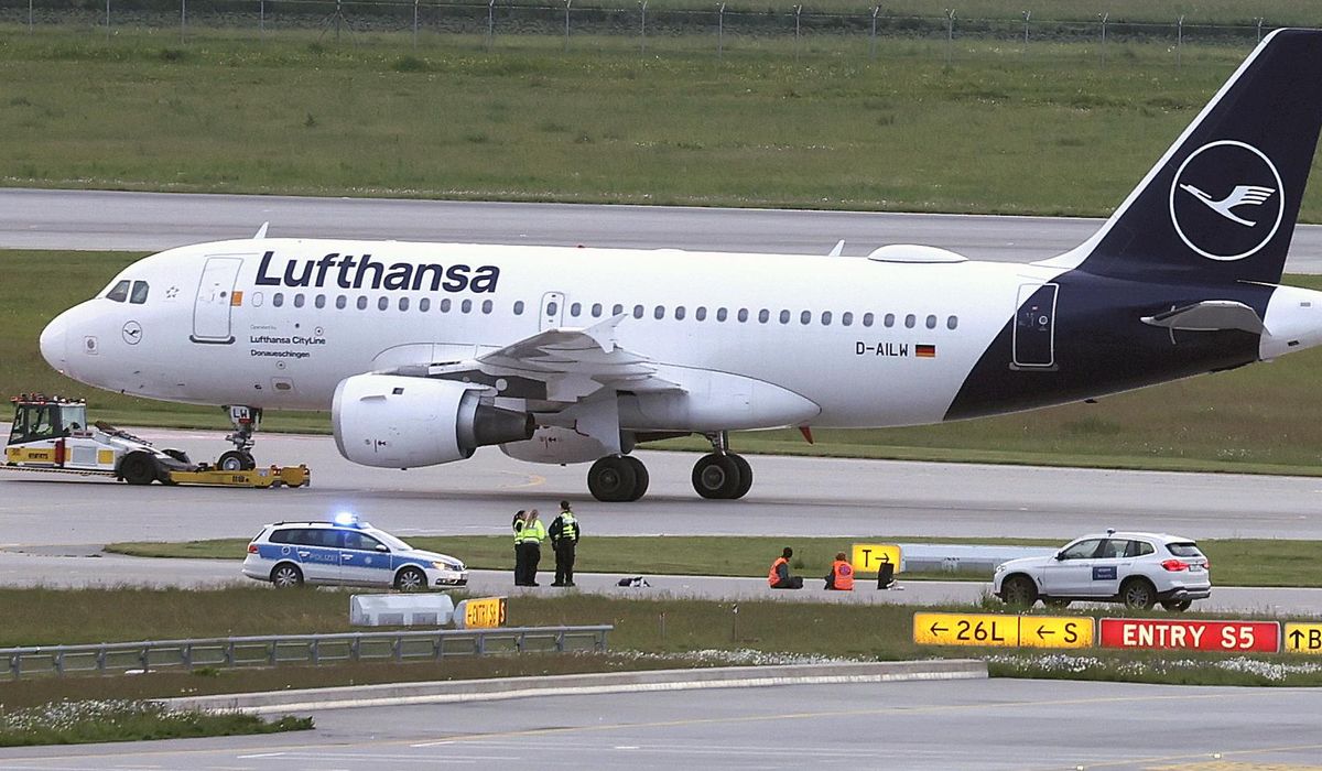 NextImg:Climate activists glue themselves at Munich airport to protest pollution caused by flying