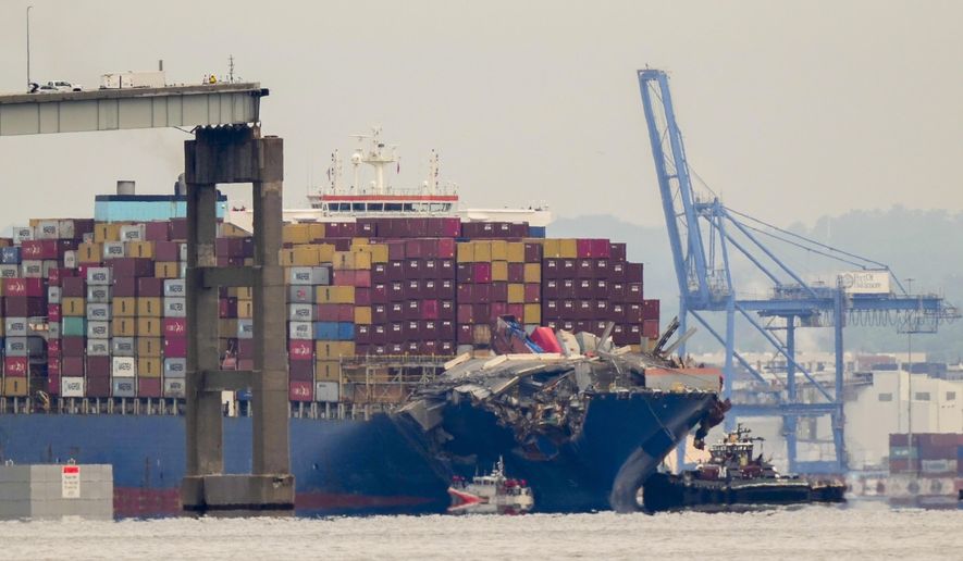 Tugboats escort the cargo ship Dali after it was refloated in Baltimore, Monday, May 20, 2024. The vessel struck the Francis Scott Key Bridge on March 26 causing it to collapse and resulting in the death of six people. (AP Photo/Matt Rourke)