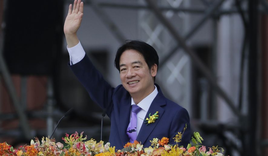 Taiwan's new President Lai Ching-te waves during his inauguration ceremonies in Taipei, Taiwan, Monday, May 20, 2024. Lai Ching-te was sworn in as Taiwan’s new president Monday, beginning a term in which he is expected to continue the self-governing island’s policy of de facto independence from China while seeking to bolster its defenses against Beijing. (AP Photo/Chiang Ying-ying)