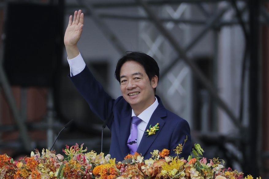 Taiwan's new President Lai Ching-te waves during his inauguration ceremonies in Taipei, Taiwan, Monday, May 20, 2024. Lai Ching-te was sworn in as Taiwan’s new president Monday, beginning a term in which he is expected to continue the self-governing island’s policy of de facto independence from China while seeking to bolster its defenses against Beijing. (AP Photo/Chiang Ying-ying)