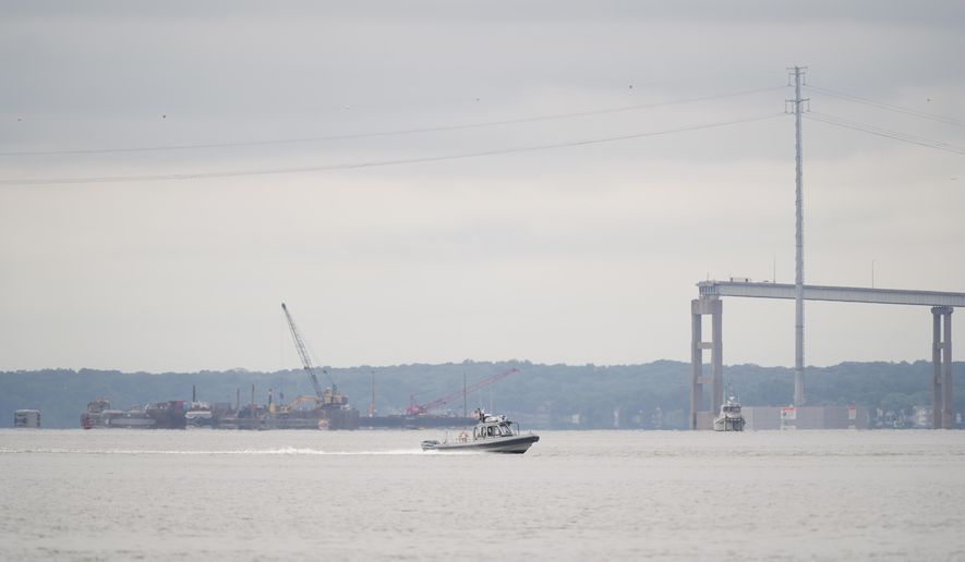 A boat passes near the collapsed Francis Scott Key Bridge, in Baltimore, Monday, May 20, 2024. (AP Photo/Matt Rourke)