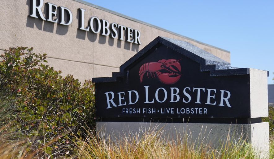 Signs for a Red Lobster restaurant are shown in San Bruno, Calif., Tuesday, May 14, 2024. Red Lobster has filed for Chapter 11 bankruptcy protection days after shuttering dozens of restaurants. The seafood chain has been struggling for some time with lease and labor costs piling up in recent years and also promotions like its iconic all-you-can-eat shrimp deal. (AP Photo/Jeff Chiu, File)
