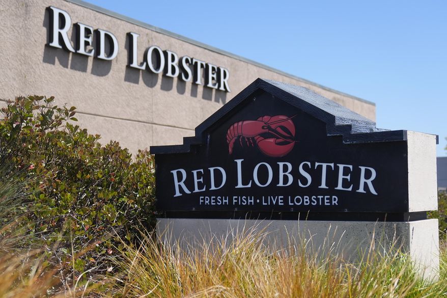 Signs for a Red Lobster restaurant are shown in San Bruno, Calif., Tuesday, May 14, 2024. Red Lobster has filed for Chapter 11 bankruptcy protection days after shuttering dozens of restaurants. The seafood chain has been struggling for some time with lease and labor costs piling up in recent years and also promotions like its iconic all-you-can-eat shrimp deal. (AP Photo/Jeff Chiu, File)