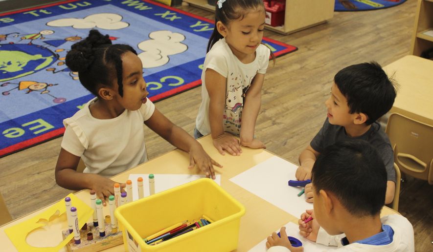 Children color at the KinderCare Child Development center on April 18, 2024, in Las Vegas. Just under 100 children of employees were enrolled at the The Venetian Las Vegas' center as of mid-April. (Jackie Valley/The Christian Science Monitor via AP)