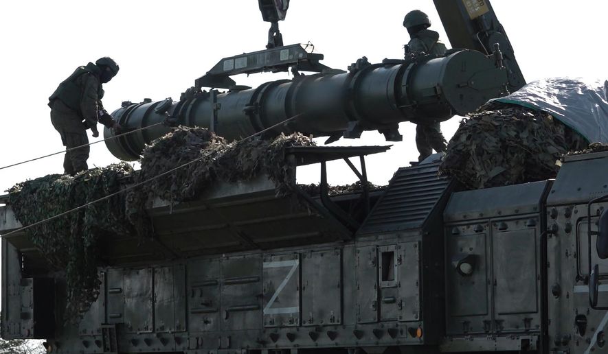 In this photo released by Russian Defense Ministry Press Service on Tuesday, May 21, 2024, Russian troops load an Iskander missile as part of drills to train the military for using tactical nuclear weapons at an undisclosed location in Russia. Russia's Defense Ministry on Tuesday said it began the first round of drills involving tactical nuclear weapons. It was the first time Russia has publicly announced drills involving tactical nuclear weapons, although its strategic nuclear forces regularly hold exercises. (Russian Defense Ministry Press Service via AP)