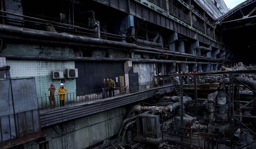 German's Foreign Minister Annalena Baerbock speaks to Ukrainian Energy Minister Herman Halushchenko during official visit to a thermal power plant which was destroyed by a Russian rocket attack in Ukraine, Tuesday, May 21, 2024. (AP Photo/Evgeniy Maloletka)