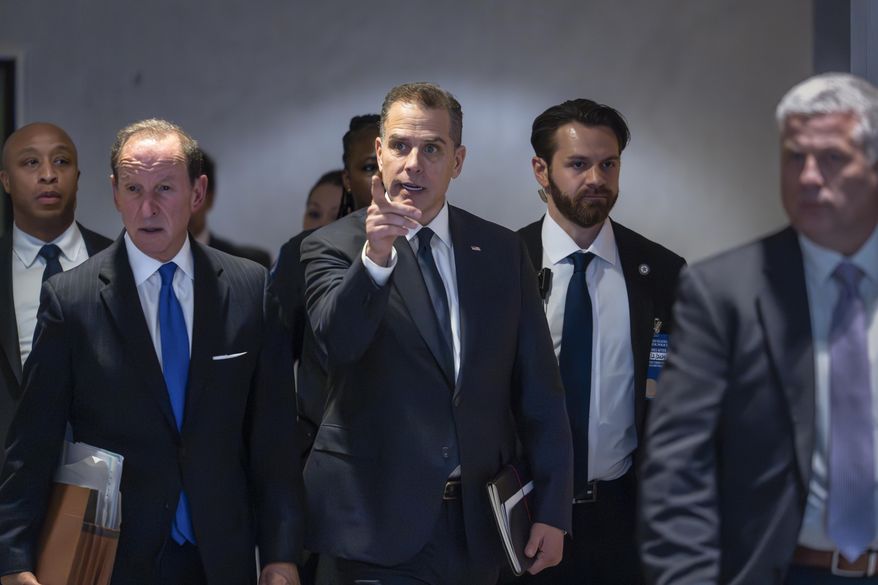Hunter Biden, son of President Joe Biden, with attorney Abbe Lowell, left, leaves after a closed-door deposition on Capitol Hill in Washington, Wednesday, Feb. 28, 2024. Biden's lawyers will press a judge Wednesday, May 22, 2024, to delay his trial in Los Angeles, set to begin next month on charges accusing him of a scheme to avoid paying $1.4 million in taxes. (AP Photo/J. Scott Applewhite,File)
