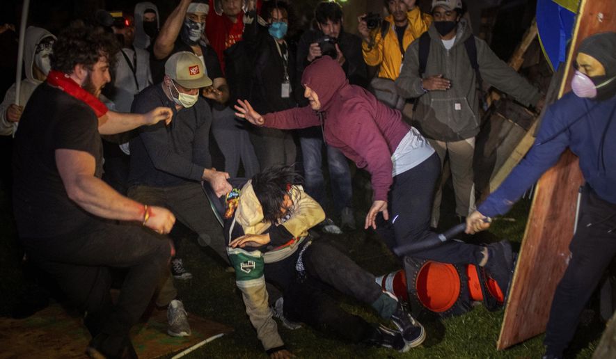 FILE - Demonstrators clash at an encampment at UCLA early Wednesday, May 1, 2024, in Los Angeles. The police chief at the University of California, Los Angeles, has been reassigned amid criticism of his handling of campus demonstrations. (AP Photo/Ethan Swope, File)