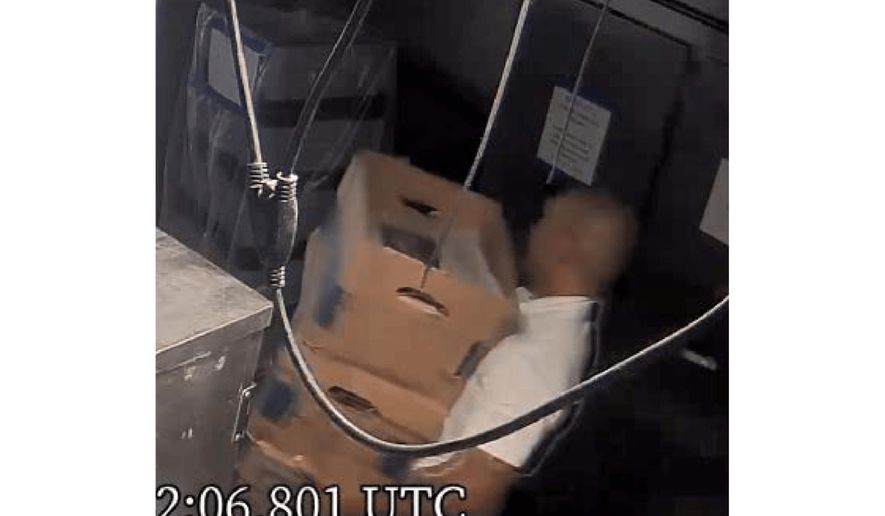 This image from video obtained by the Justice Department and included as part of an exhibit in a motion filed by the defense team to suppress boxes of records seized at Mar-a-Lago, shows Walt Nauta, personal aide to former President Donald Trump, carrying boxes at the Palm Beach, Fla., estate. (Justice Department via AP)