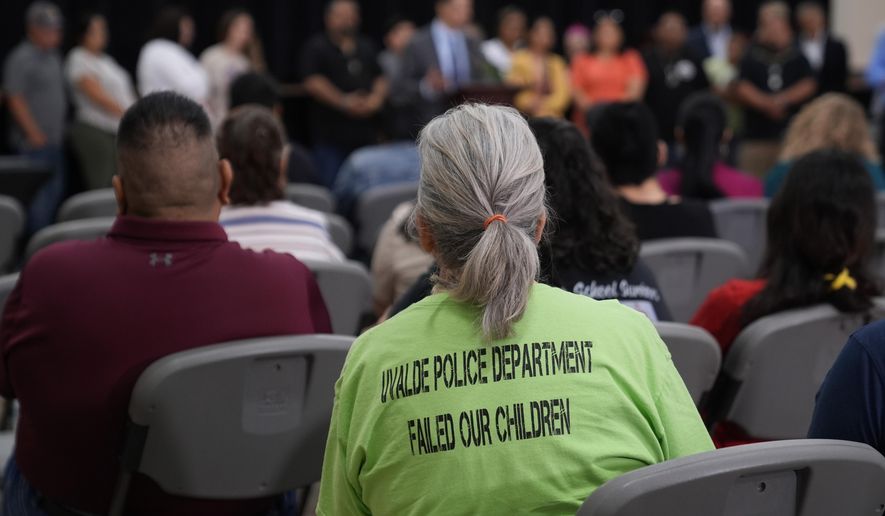 Families of the victims in the Uvalde elementary school shooting listen to attorney Josh Koskoff during a news conference, Wednesday, May 22, 2024, in Uvalde, Texas. The families of 19 of the victims announced a lawsuit against nearly 100 state police officers who were part of the botched law enforcement response. The families say they also agreed a $2 million settlement with the city, under which city leaders promised higher standards and better training for local police. (AP Photo/Eric Gay)