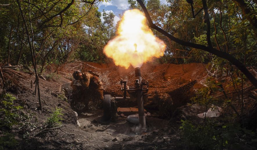 Servicemen of Ukraine's 93rd Mechanised Brigade fire a French MO-120-RT heavy mortar at the Russian forces on the front line near the city of Bakhmut in Ukraine's Donetsk region on Wednesday, May 22, 2024. (Iryna Rybakova via AP)