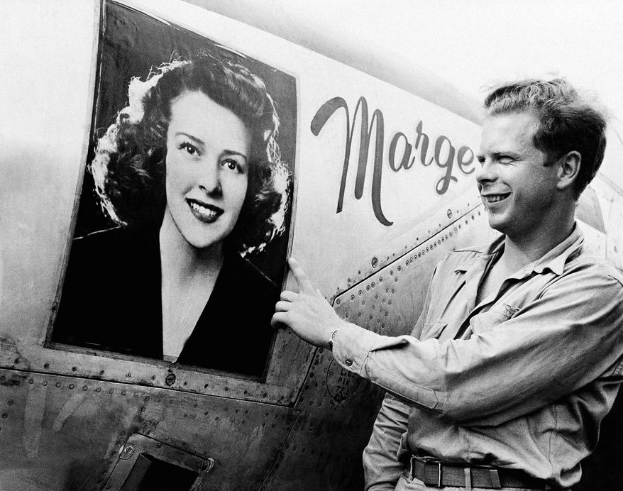 Captain Richard J. Bong, of Poplar, Wis., points to a large picture of his girl friend, Marge Vattendahl, on his Lighting P-38 fighter plane pilot stationed at a New Guinea Air Base, March 31, 1944. Searchers announced Thursday, May 23, 2024, that they've discovered what they believe is the wreckage of World War II ace Bong's plane in the South Pacific. (AP Photo, File)