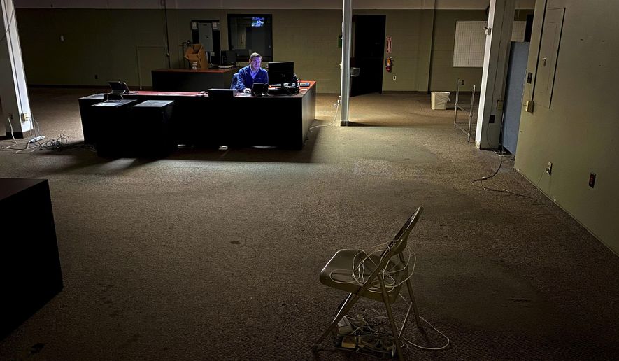 News Editor Chris Sciria puts the newspaper to bed for the last time from an empty newsroom at The Citizen's 25 Dill St. location in Auburn, N.Y. on Friday, Oct. 22, 2021. After 51 years on Dill St. the newspaper moved its operation to a smaller office space. New York is offering up to $90 million in tax credits for news outlets to hire and retain journalists in an effort to help keep the shrinking local news industry afloat. (Kevin Rivoli/The Citizen via AP, File)