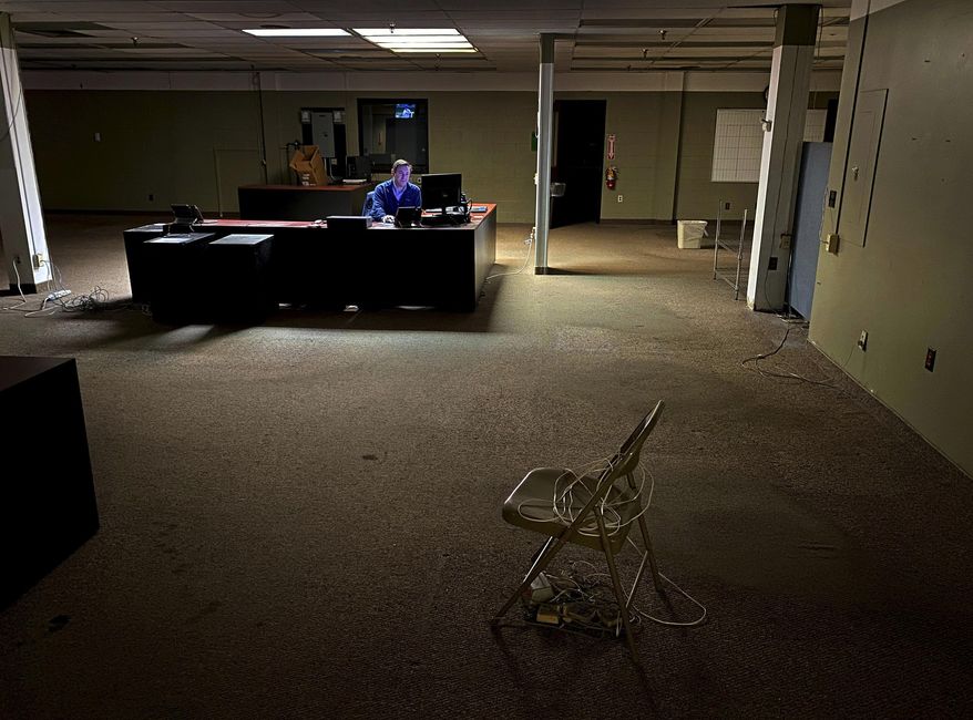 News Editor Chris Sciria puts the newspaper to bed for the last time from an empty newsroom at The Citizen's 25 Dill St. location in Auburn, N.Y. on Friday, Oct. 22, 2021. After 51 years on Dill St. the newspaper moved its operation to a smaller office space. New York is offering up to $90 million in tax credits for news outlets to hire and retain journalists in an effort to help keep the shrinking local news industry afloat. (Kevin Rivoli/The Citizen via AP, File)