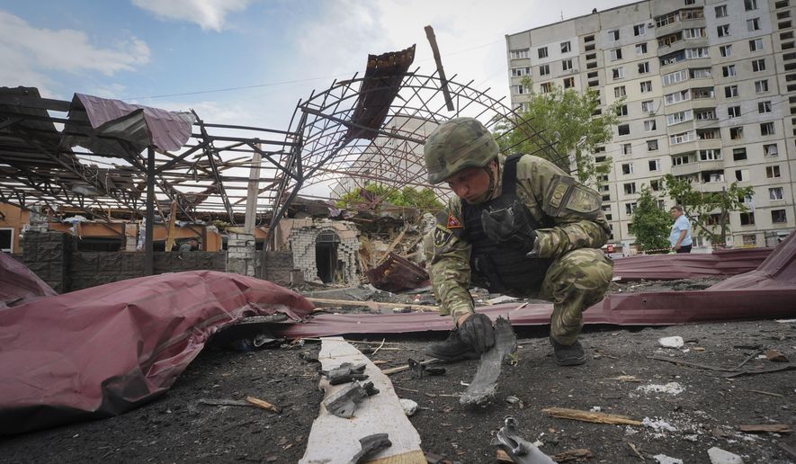 FILE - A sapper inspects fragments of a Russian air bomb that hit a living area injuring ten in Kharkiv, Ukraine, May 22, 2024. Two U.S. officials say the Biden administration is expected to announce an additional $275 million in military aid for Ukraine on Friday. It comes as Kyiv struggles to hold off advances by Russian troops in the Kharkiv region. This will be the fourth installment of military aid for Ukraine since Congress passed a long-delayed foreign aid bill late last month.(AP Photo/Andrii Marienko, File)