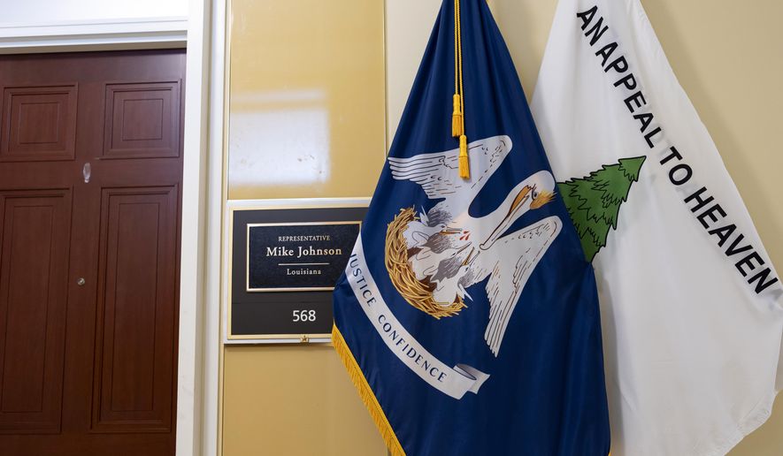 The Appeal to Heaven flag stands with the Louisiana state flag outside the district office of Speaker of the House Mike Johnson, R-La., in the Cannon House Office Building, at the Capitol in Washington, Thursday, May 23, 2024. Supreme Court Justice Samuel Alito is embroiled in a second flag controversy, this time over the “Appeal to Heaven” flag, a banner that in recent years has come to symbolize Christian nationalism and the false claim that the 2020 presidential election was stolen. The flag was seen outside his New Jersey beach home last summer. (AP Photo/J. Scott Applewhite)