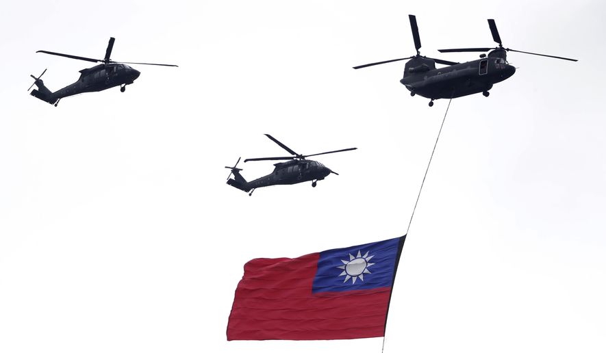 Helicopters fly over with Taiwan national flag during an inauguration celebration of Taiwan's President Lai Ching-te in Taipei, Taiwan, on May 20, 2024. China's military held exercises surrounding Taiwan on Thursday, May 23, 2024, in what it called punishment for separatist forces seeking independence on the self-governed island where a new president took office this week. (AP Photo/Chiang Ying-ying, File)