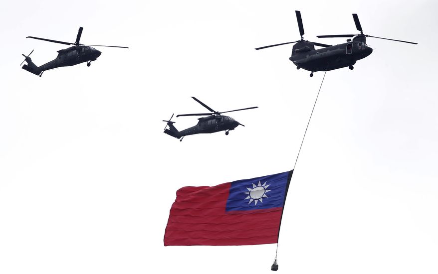 Helicopters fly over with Taiwan national flag during an inauguration celebration of Taiwan's President Lai Ching-te in Taipei, Taiwan, on May 20, 2024. China's military held exercises surrounding Taiwan on Thursday, May 23, 2024, in what it called punishment for separatist forces seeking independence on the self-governed island where a new president took office this week. (AP Photo/Chiang Ying-ying, File)