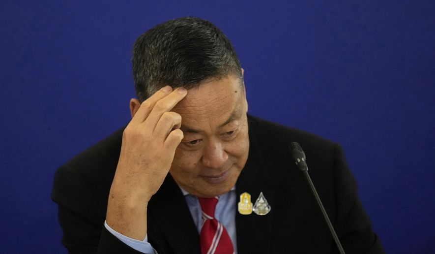 File- Thailand's Prime Minister Srettha Thavisin gestures as he talks to media during a news conference at the government house in Bangkok, Thailand, Wednesday, April 10, 2024. Thailand’s Constitutional Court on Thursday, May 23, accepted a petition from members of the country’s outgoing Senate to consider suspending Thavisin from office over his appointment of a Cabinet member. The court ruled that Srettha’s appointment of Pichit Chuenban as Minister of the Prime Minister’s Office was in violation of section 160 of the constitution, which bars those who have been sentenced to imprisonment or those who fail to comply with “ethical standards.” (AP Photo/Sakchai Lalit, File)