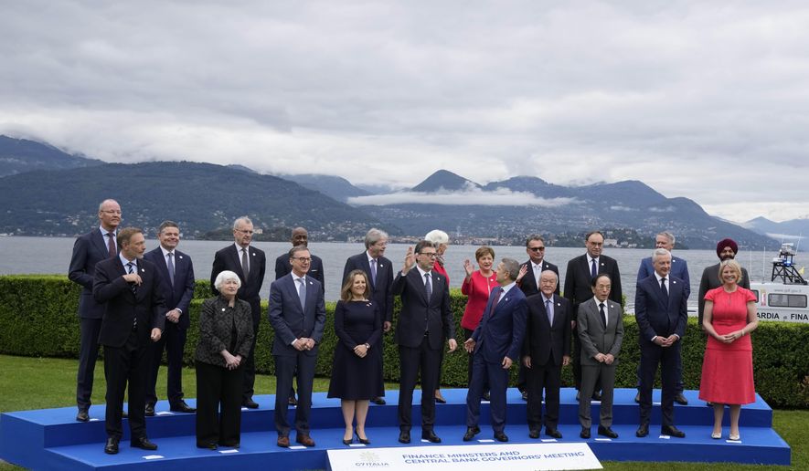 Finance Ministers and Central Bank Governors pose for the family picture at the G7 Finance Ministers meeting in Stresa, northern Italy, Friday, May 24, 2024. (AP Photo/Antonio Calanni)