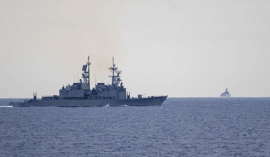 In this photo released by the Taiwan Ministry of National Defense, Taiwan guided missile destroyer Ma Kong DDG1805, left, monitors Chinese guided missile destroyer Xi'an DDG15, right, near Taiwan on Thursday, May 23, 2024. Taiwan tracked dozens of Chinese warplanes and navy vessels off its coast Friday on the second day of a large exercise China's People's Liberation Army held in response to the inauguration of the island's new leadership. (Taiwan Ministry of National Defense via AP)