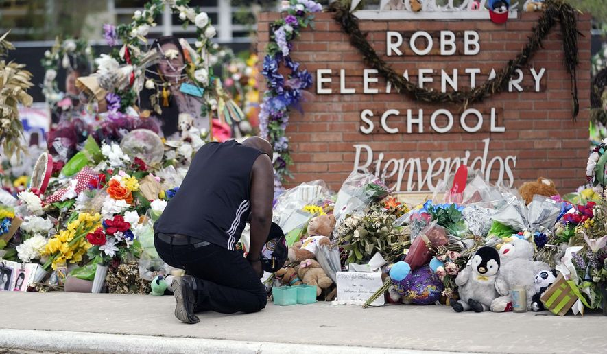 Reggie Daniels pays his respects a memorial at Robb Elementary School, Thursday, June 9, 2022, in Uvalde, Texas. The 19 fourth-graders and two teachers killed at the elementary school are being remembered, Friday, May 24, 2024 as the second anniversary of the one of the deadliest school shootings in U.S. history is marked. (AP Photo/Eric Gay)