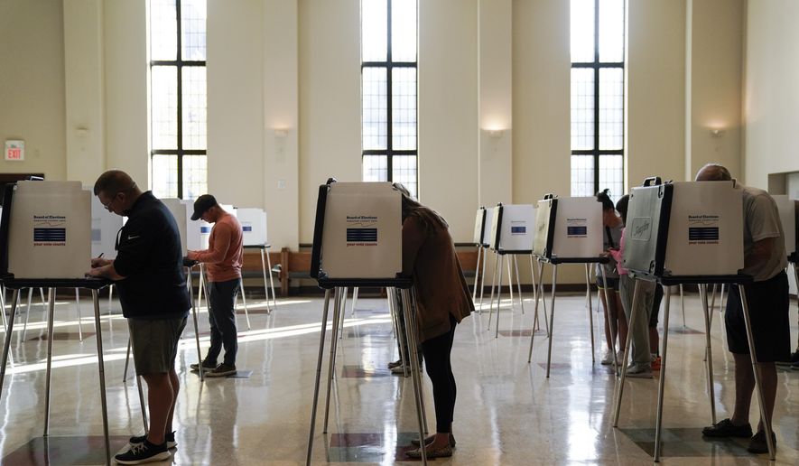 People vote on Election Day, Nov. 7, 2023, at Knox Presbyterian Church in Cincinnati. The Democratic National Committee will hold a virtual roll call to officially make President Biden the Democratic nominee before the party's August convention so he can make it onto the Ohio ballot, the committee said. (AP Photo/Joshua A. Bickel, File)