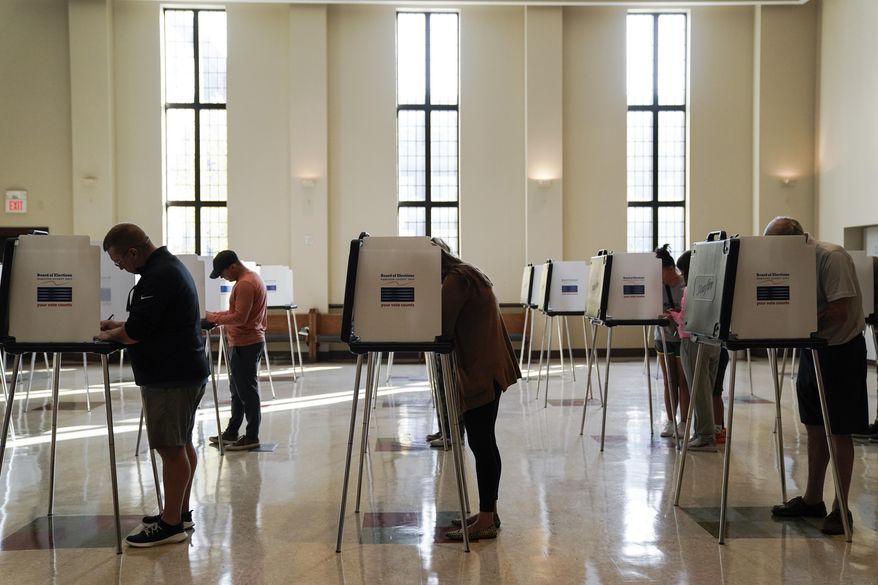 People vote on Election Day, Nov. 7, 2023, at Knox Presbyterian Church in Cincinnati. The Democratic National Committee will hold a virtual roll call to officially make President Biden the Democratic nominee before the party's August convention so he can make it onto the Ohio ballot, the committee said. (AP Photo/Joshua A. Bickel, File)