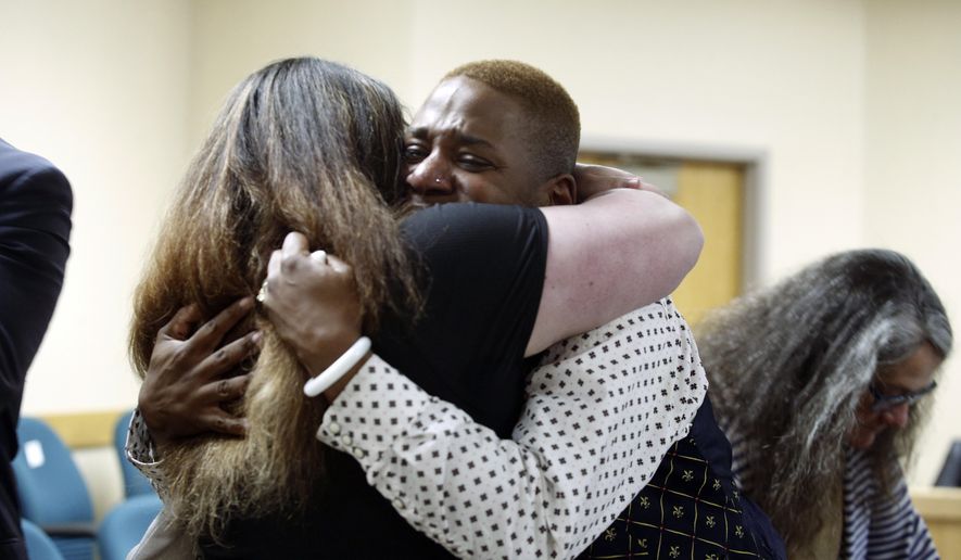 Eric Posey, of Post Falls, Idaho, embraces a supporter in court, after a jury awarded him more than $1.1 million in damages in his defamation lawsuit against conservative blogger Summer Bushnell, Friday, May 24, 2024, in Coeur D'Alene, Idaho. Posey said he suffered harassment and death threats after Bushnell falsely accused him of exposing himself to minors during a performance in 2022. (Kaye Thornbrugh/Coeur D'Alene Press via AP)