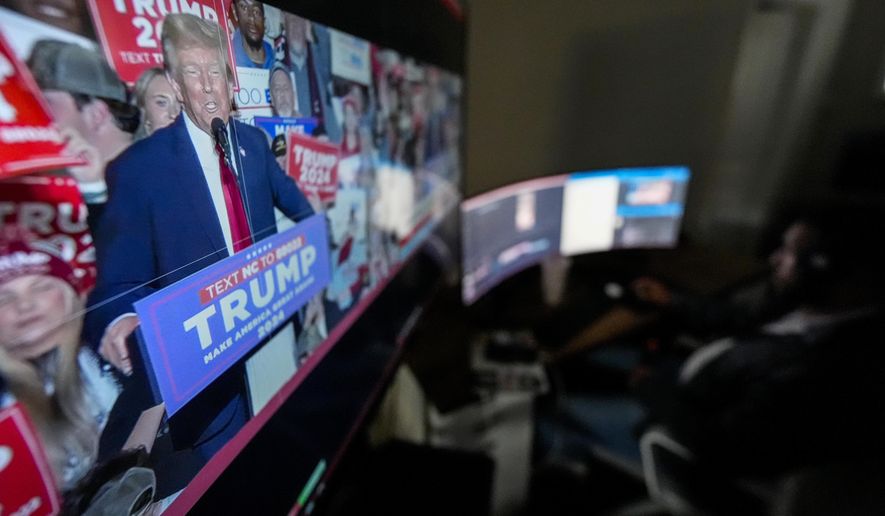 Monitors at Right Side Broadcasting Network in Opelika, Ala., display Republican presidential candidate former President Donald Trump speaking at a campaign rally in North Carolina on Saturday, March 2, 2024. In less than a decade, RSBN has gone from upstart internet broadcaster to major player in Trump's MAGA universe, amassing more than two million subscribers on its YouTube channel and on Rumble, an alternative video-sharing platform. (AP Photo/Mike Stewart)