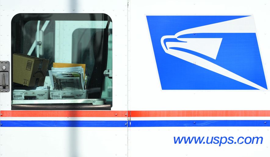 Letters and packages are loaded on a U.S. Postal Service truck parked outside a post office in Wheeling, Ill., Monday, Jan. 29, 2024. As many Americans celebrate Memorial Day on Monday, May 27, 2024, there are several stores, government offices and businesses that will be open or closed. (AP Photo/Nam Y. Huh, File)