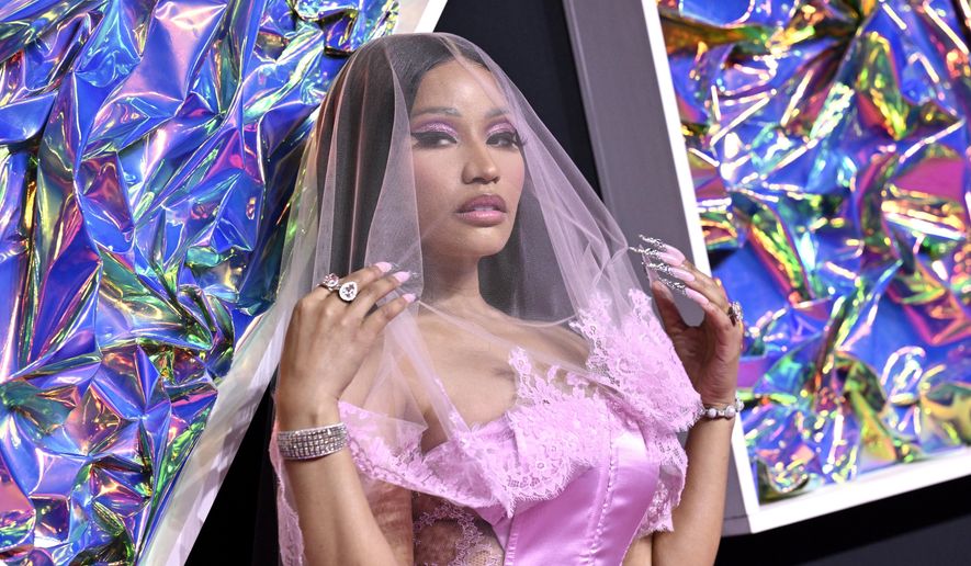 Rapper Nicki Minaj arrives at the MTV Video Music Awards on Sept. 12, 2023, at the Prudential Center in Newark, N.J. Minaj says bags were searched on the way out of the Netherlands. She tweeted that police told her they found marijuana in her bags. The military constabulary at the airport said a 41-year-old American woman had been arrested for exporting “soft drugs.” (Photo by Evan Agostini/Invision/AP, File)