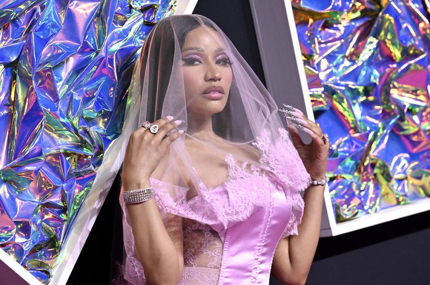 Rapper Nicki Minaj arrives at the MTV Video Music Awards on Sept. 12, 2023, at the Prudential Center in Newark, N.J. Minaj says bags were searched on the way out of the Netherlands. She tweeted that police told her they found marijuana in her bags. The military constabulary at the airport said a 41-year-old American woman had been arrested for exporting “soft drugs.” (Photo by Evan Agostini/Invision/AP, File)
