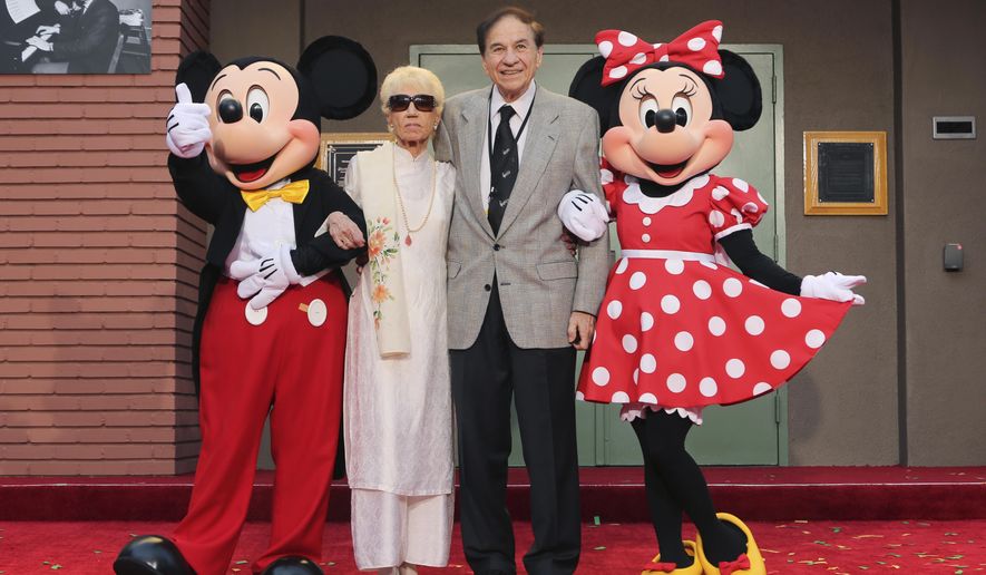 Mickey Mouse, from left, Elizabeth Gluck, Richard M. Sherman and Minnie Mouse pose for a photo at the ceremony honoring the Sherman Brothers with the rename of Disney Studios Soundstage A at the world premiere of Disney's "Christopher Robin" at the Walt Disney Studios, July 30, 2018, in Burbank, Calif. Sherman, one half of the prolific, award-winning pair of brothers who helped form millions of childhoods by penning classic Disney tunes, died Saturday, May 25, 2024. He was 95. (Photo by Willy Sanjuan/Invision/AP, File)