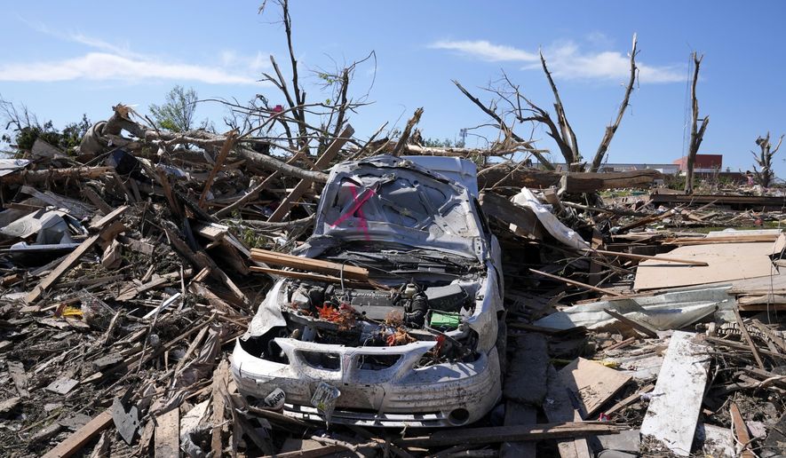 A tornado damaged car sits in a pile of debris, Thursday, May 23, 2024, in Greenfield, Iowa. Experts say that planning is key before a tornado threatens. They say weather radios, basements and bicycle helmets all save lives. Record warmth this winter provided the fuel for a deadly tornado outbreak across parts of the Midwest and South in March. (AP Photo/Charlie Neibergall, File)