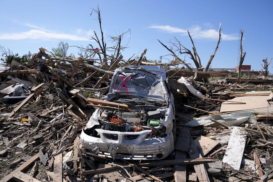 A tornado damaged car sits in a pile of debris, Thursday, May 23, 2024, in Greenfield, Iowa. Experts say that planning is key before a tornado threatens. They say weather radios, basements and bicycle helmets all save lives. Record warmth this winter provided the fuel for a deadly tornado outbreak across parts of the Midwest and South in March. (AP Photo/Charlie Neibergall, File)