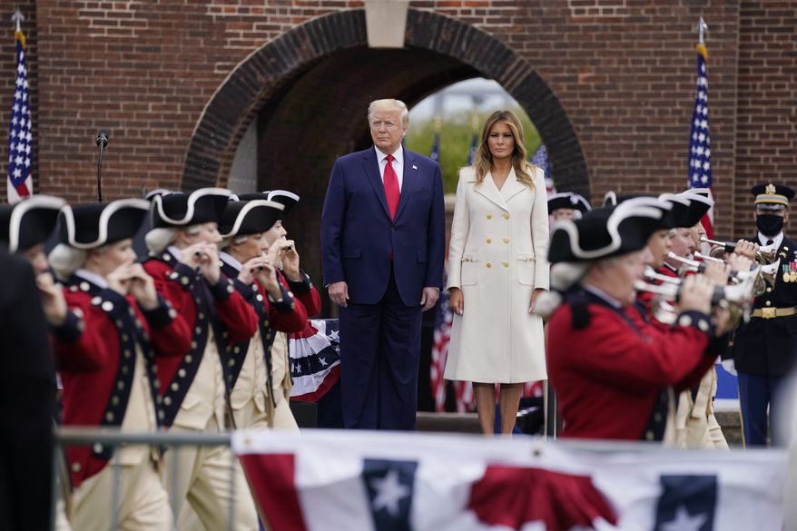 President Donald Trump and first lady Melania Trump participate in a Memorial Day ceremony at Fort McHenry National Monument and Historic Shrine, Monday, May 25, 2020, in Baltimore. (AP Photo/Evan Vucci)