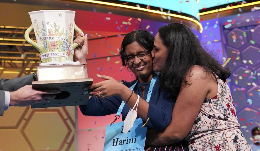 Harini Logan, 14, from San Antonio, Texas, gets a kiss from her mom Rampriya Logan on stage as she celebrates winning the Scripps National Spelling Bee, Thursday, June 2, 2022, in Oxon Hill, Md. Since 1999, 28 of the last 34 Scripps National Spelling bee champions have been Indian American. The experiences of first-generation Indian Americans and their spelling bee champion children illustrate the economic success and cultural impact of the nation’s second-largest immigrant group. (AP Photo/Alex Brandon, File)