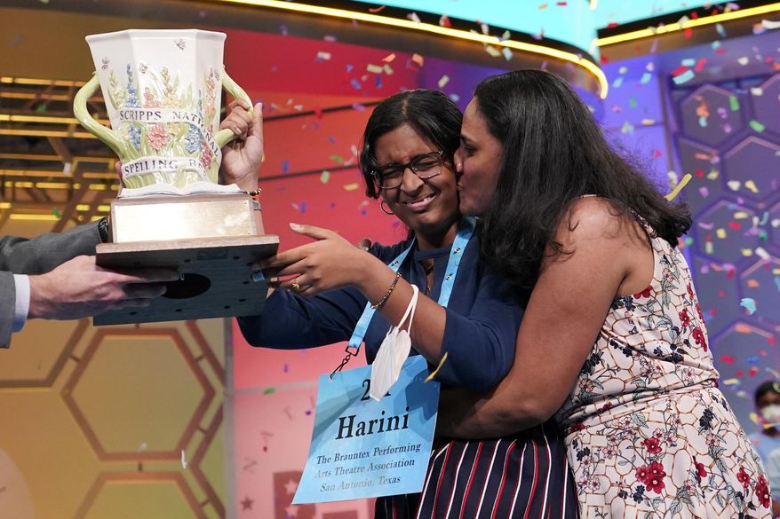 Harini Logan, 14, from San Antonio, Texas, gets a kiss from her mom Rampriya Logan on stage as she celebrates winning the Scripps National Spelling Bee, Thursday, June 2, 2022, in Oxon Hill, Md. Since 1999, 28 of the last 34 Scripps National Spelling bee champions have been Indian American. The experiences of first-generation Indian Americans and their spelling bee champion children illustrate the economic success and cultural impact of the nation’s second-largest immigrant group. (AP Photo/Alex Brandon, File)