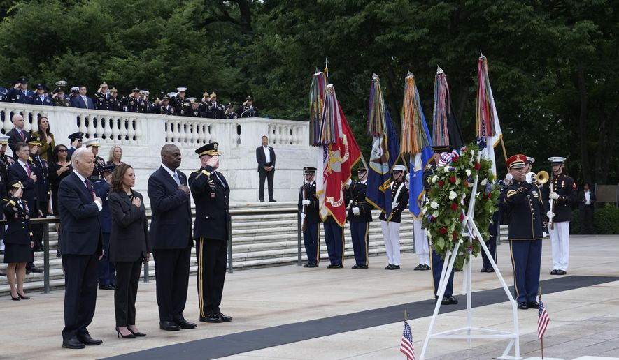 President Joe Biden, left, joined by, from left, Vice President Kamala Harris, Defense Secretary Lloyd Austin and Army Major Gen. Trevor Bradenkamp, listen to the playing of Taps during an Armed Forces Full Honors Wreath Ceremony at the Tomb of the Unknown Soldier at Arlington National Cemetery in Arlington, Va., on Memorial Day, Monday, May 27, 2024. (AP Photo/Susan Walsh)