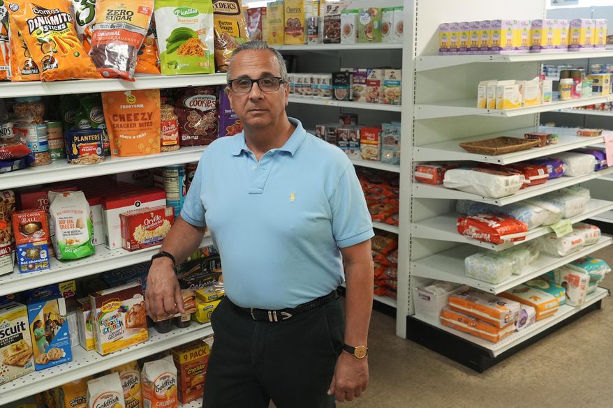Rob Ranieri, CEO of House of Hope, stands in the food pantry, Tuesday, May 21, 2024, in Stuart, Fla. House of Hope offers food, clothing, financial and life skills to residents of Martin County. The Community Foundation of Martin - St. Lucie counties has overhauled its approach to disaster response by creating a permanent fund and establishing preemptive agreements with nonprofit partners like House of Hope to deploy funds to them immediately when a storm is forecasted. (AP Photo/Marta Lavandier)