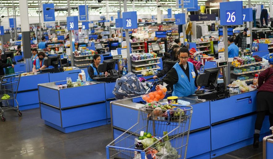Cashiers process purchases at a Walmart Supercenter in North Bergen, N.J., on Feb. 9, 2023. Retailers, including Walmart and Target, are stepping up discounting heading into the summer of 2024, as they hope to offer frustrated shoppers some relief from higher prices and entice them to open their wallets.(AP Photo/Eduardo Munoz Alvarez, File)