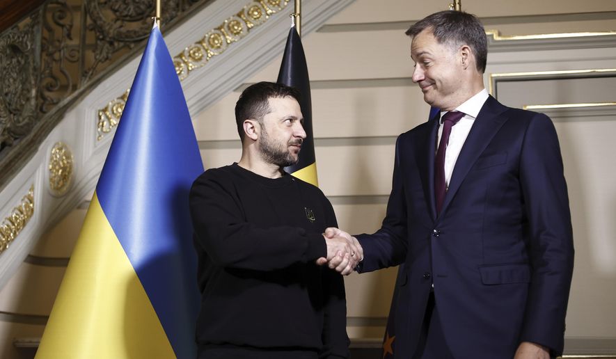 Ukraine's President Volodymyr Zelenskyy, left, shakes hands with Belgium's Prime Minister Alexander De Croo during their meeting at the prime ministers' office in Brussels, Tuesday, May 28, 2024. (Kenzo Tribouillard/Pool Photo via AP)
