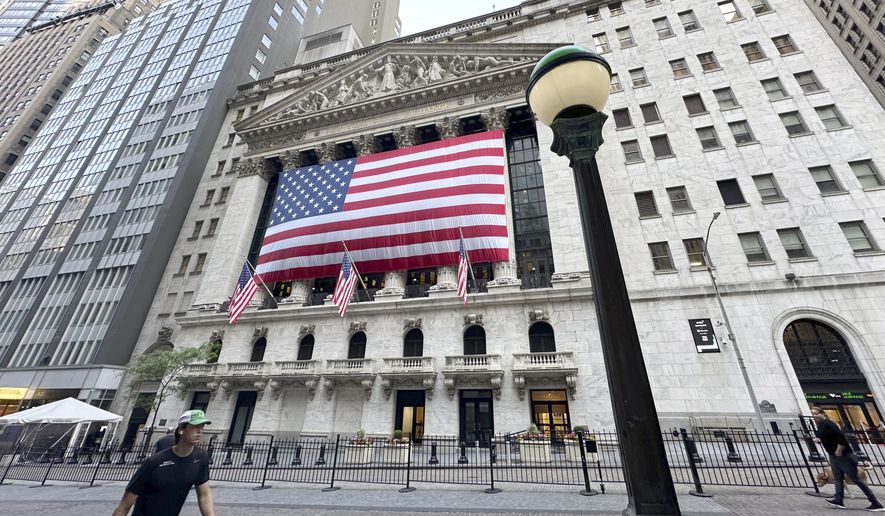 People pass the New York Stock Exchange on Tuesday, May 28, 2024, in New York. Shares are mostly lower in Europe and Asia after U.S. markets were closed for the Memorial Day holiday. (AP Photo/Peter Morgan, File)