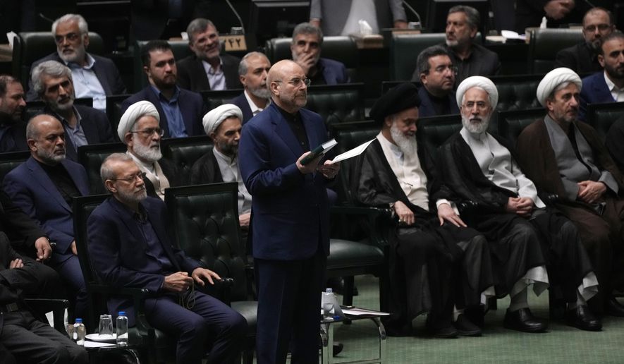 Mohammad Bagher Qalibaf, center, takes an oath during the opening ceremony of the new Parliament term in Tehran, Iran, Monday, May 27, 2024. Iran's Parliament reelected hard-liner Qalibaf on Tuesday as its speaker, reaffirming its hard-right makeup in the wake of a helicopter crash that killed the country's president and foreign minister. (AP Photo/Vahid Salemi)